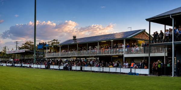Outdoor community sports club facility with solar panels installed on clubhouse roof representing the Game On grant program.